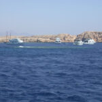 Tauchboote vor Anker vor den hellen Klippen von Ras Mohammed, über dem Shark und Yolanda Reef