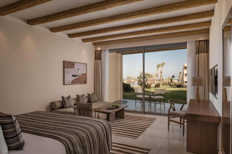 Ein Zimmer mit Sitzecke, offen zu einer Terrasse und zum Garten