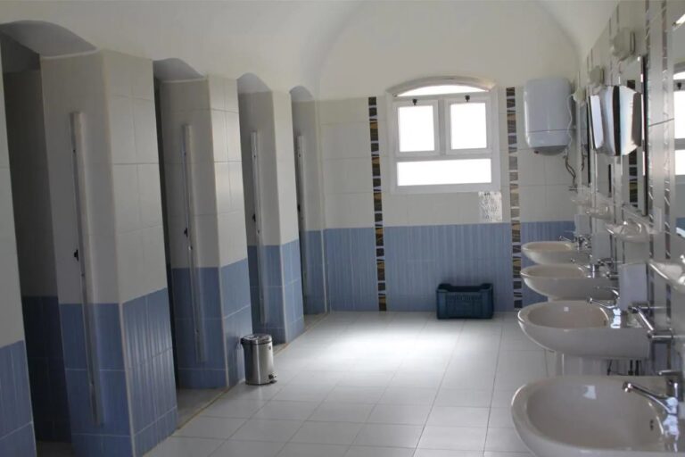 Ein Sanitärblock mit einer Reihe von Kabinen und Waschbecken
